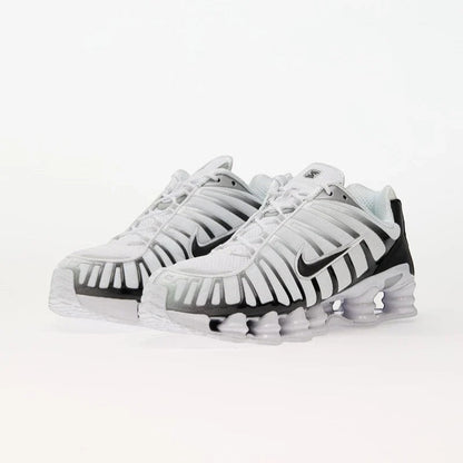 Nike Shox TL White/Black-Metallic Platinum sneakers with breathable mesh and TPU overlays for support.